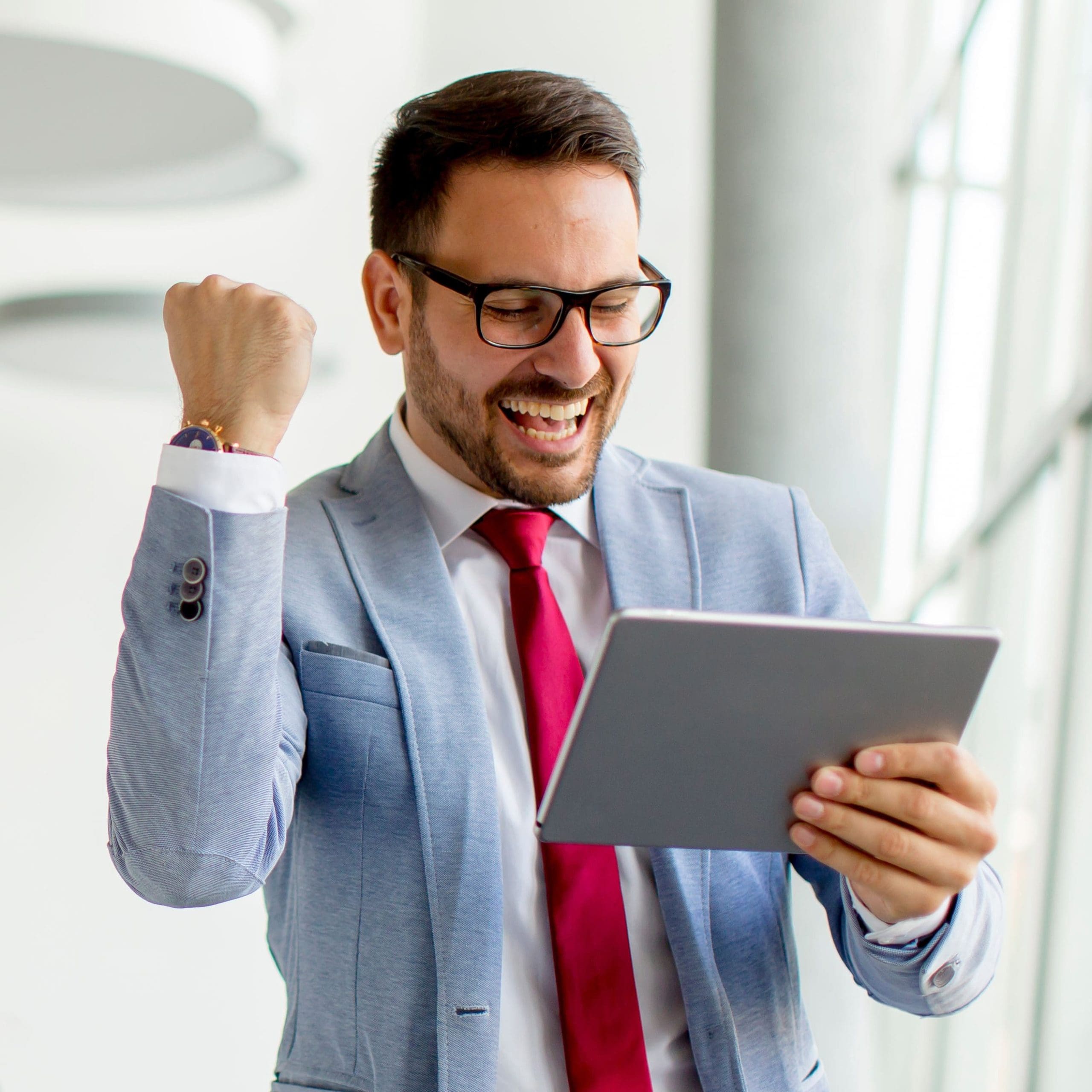 Portrait of young businessman with digital tablet in office